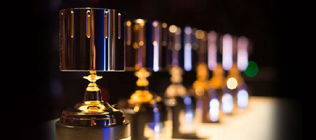 Row of golden Annie Award trophies.